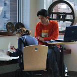 Two students studying near the windows in the Musagetes Library