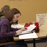 Female student studying at a quiet study table in the Porter Library